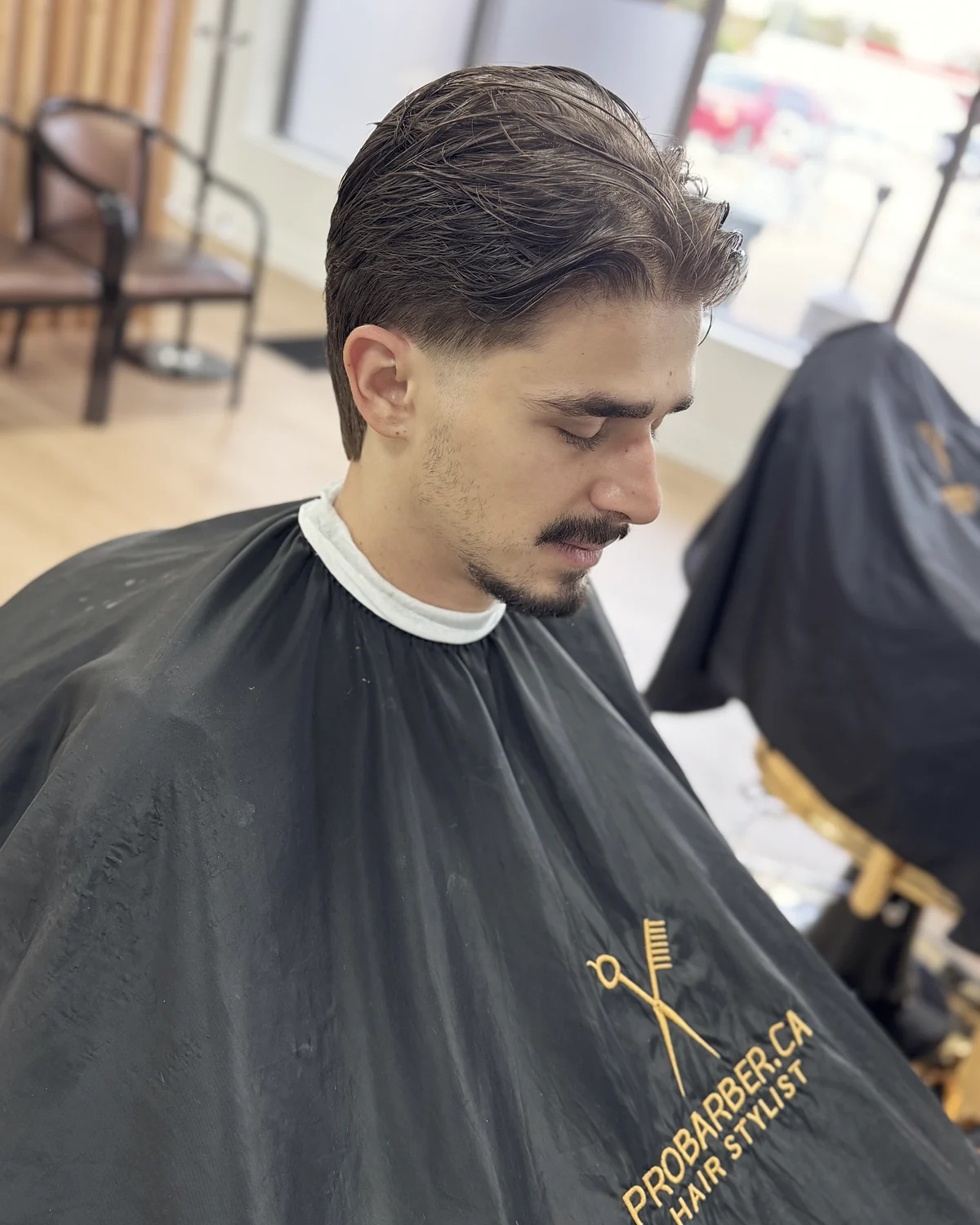 Client in a Probarber cape after a textured haircut